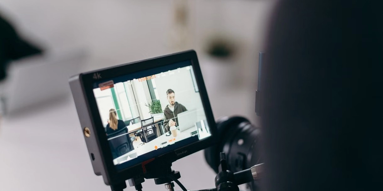Customer sharing a real story on camera during an unscripted interview in a natural office with a small production crew